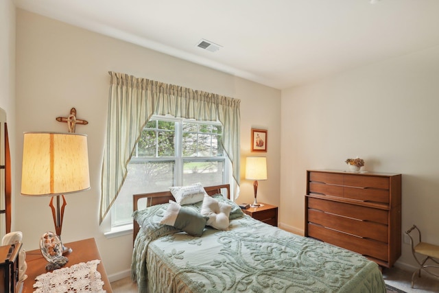 bedroom with visible vents, carpet flooring, and baseboards