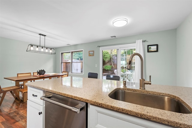 110 Gedney St, Nyack, NY 10960 - kitchen with dishwasher, white cabinetry, pendant lighting, light stone counters, and dark wood-style floors