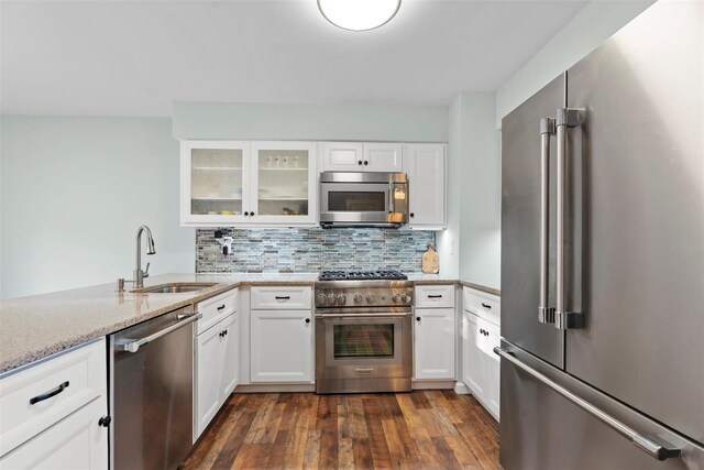 110 Gedney St, Nyack, NY 10960 - kitchen with premium appliances, backsplash, white cabinetry, and light stone countertops