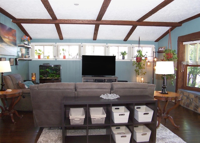 living area with vaulted ceiling with beams and wood finished floors