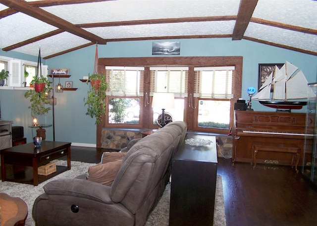 living area featuring lofted ceiling with beams and a healthy amount of sunlight