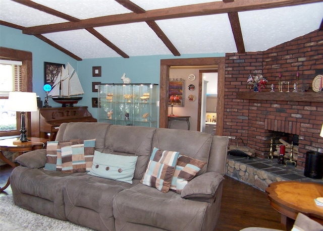 living area with a fireplace, lofted ceiling with beams, and wood finished floors