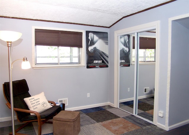 sitting room featuring visible vents, ornamental molding, baseboards, and lofted ceiling