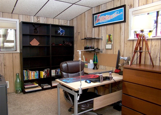 carpeted office featuring wooden walls