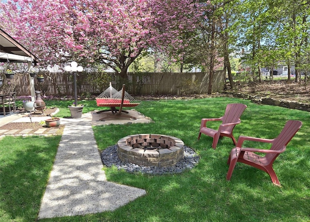 view of yard featuring fence and an outdoor fire pit