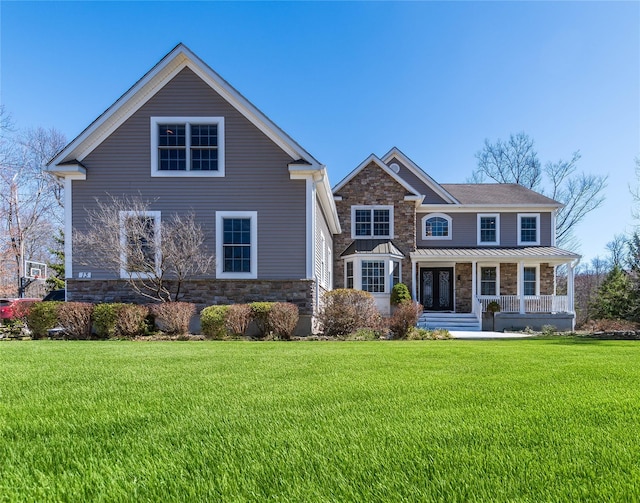 13 Orr-Hatch Dr, Cornwall, NY 12518 - view of front of home featuring stone siding, a porch, a front yard, and a standing seam roof