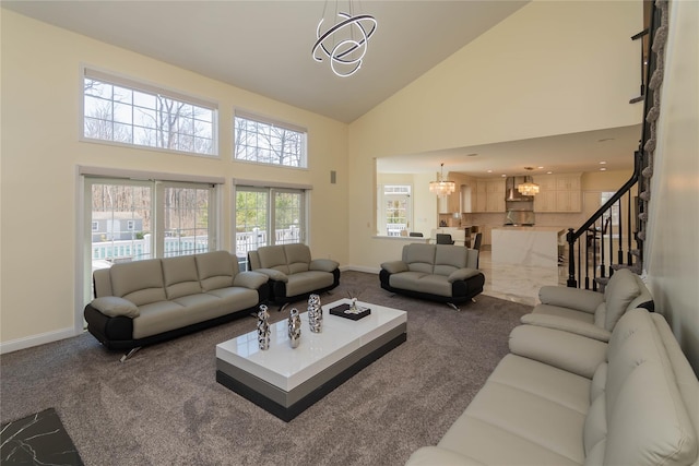 13 Orr-Hatch Dr, Cornwall, NY 12518 - carpeted living room with high vaulted ceiling, a chandelier, baseboards, and stairway