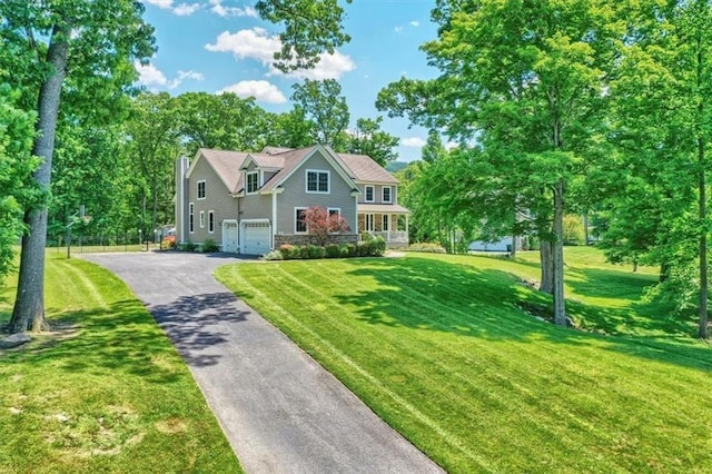 13 Orr-Hatch Dr, Cornwall, NY 12518 - view of front of home with asphalt driveway, an attached garage, stone siding, and a front lawn