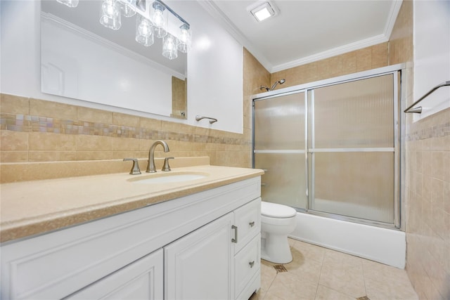 full bath featuring crown molding, toilet, tile walls, tile patterned floors, and vanity