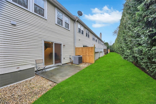 back of house with a lawn, fence, a patio, and central air condition unit