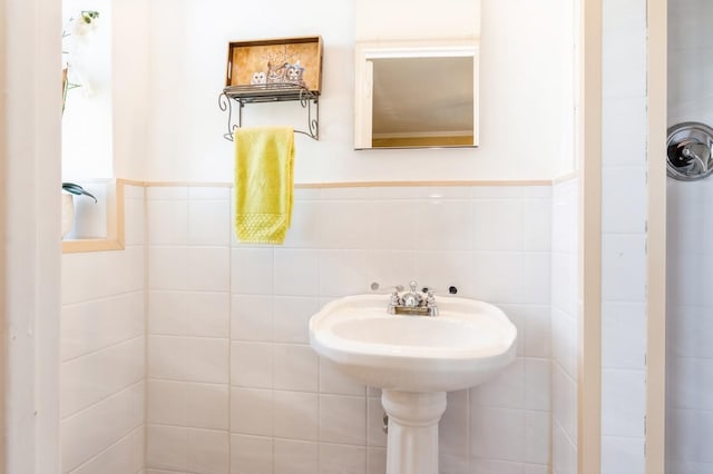 bathroom featuring tile walls and a wainscoted wall