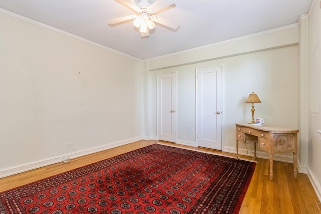 unfurnished bedroom featuring baseboards, ornamental molding, and wood finished floors