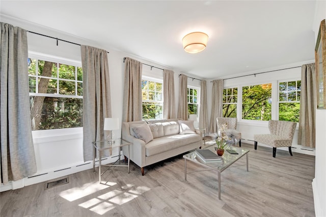 sunroom / solarium featuring a baseboard heating unit and visible vents