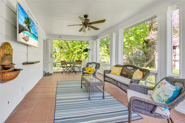 sunroom with a ceiling fan and a wealth of natural light