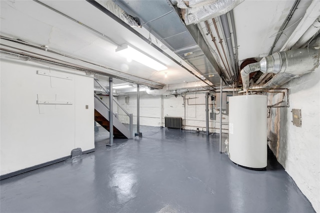 unfinished basement with water heater, radiator heating unit, and stairway
