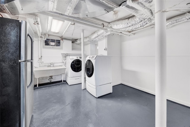 washroom with independent washer and dryer, laundry area, and a sink