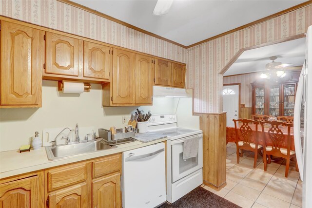 kitchen with white appliances, wallpapered walls, under cabinet range hood, a sink, and ceiling fan