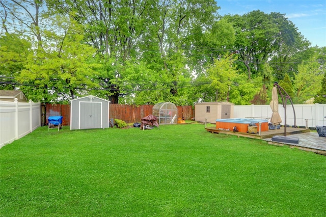view of yard with a storage shed, an outdoor structure, and a wooden deck