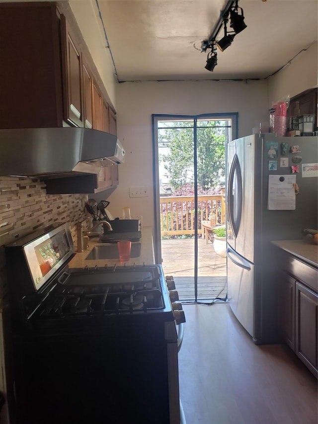 2261 Story Ave, Bronx, NY 10473 - kitchen with stainless steel appliances, ventilation hood, and decorative backsplash