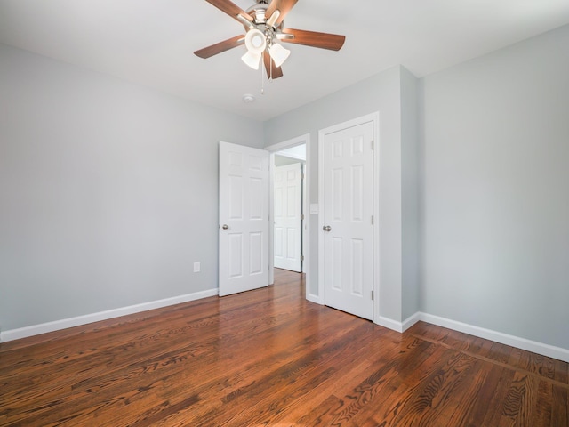 unfurnished bedroom featuring baseboards, wood finished floors, and ceiling fan