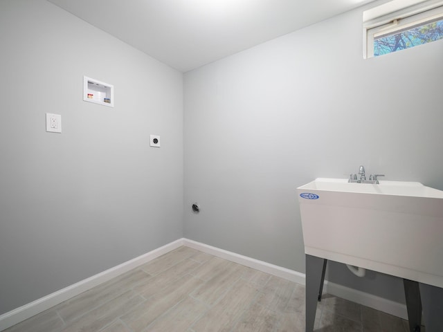 laundry area with electric dryer hookup, light wood-style floors, baseboards, hookup for a washing machine, and laundry area