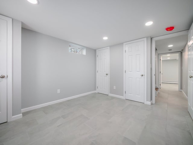 unfurnished bedroom featuring a baseboard radiator, recessed lighting, and baseboards