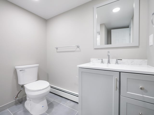 bathroom with baseboard heating, tile patterned floors, toilet, and vanity