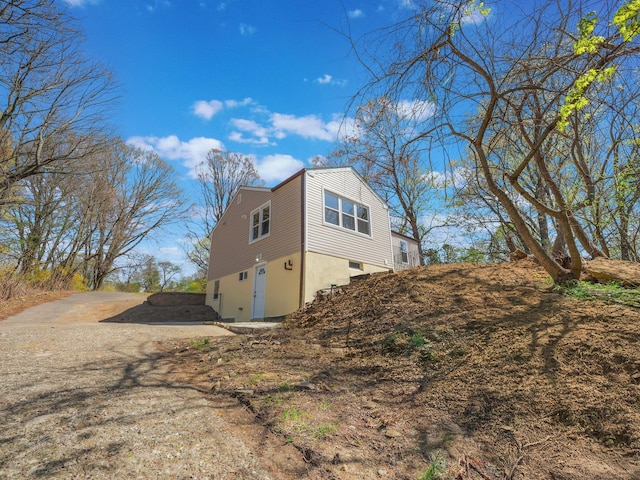 view of side of home with stucco siding