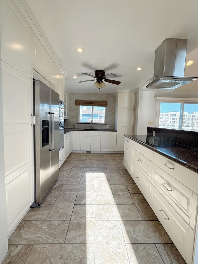kitchen featuring white cabinets, island range hood, ceiling fan, recessed lighting, and high end refrigerator
