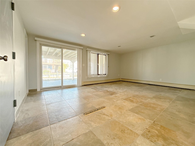 empty room with stone tile flooring, recessed lighting, and baseboards