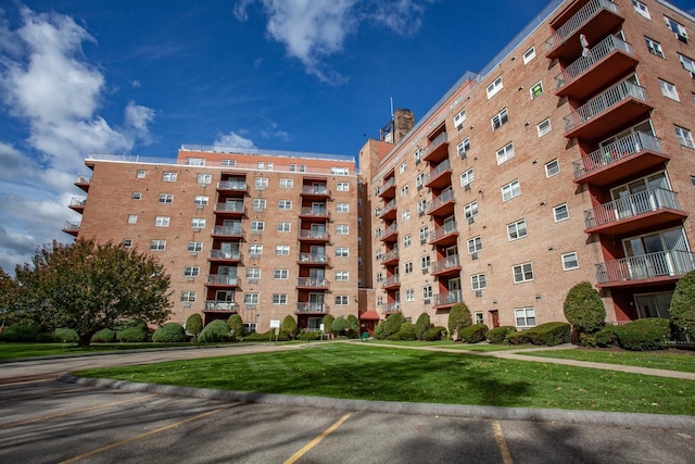 view of building exterior with uncovered parking