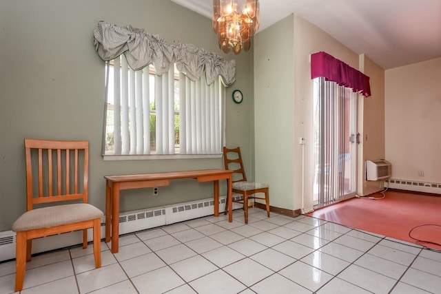 sitting room featuring an inviting chandelier, a baseboard radiator, and a healthy amount of sunlight