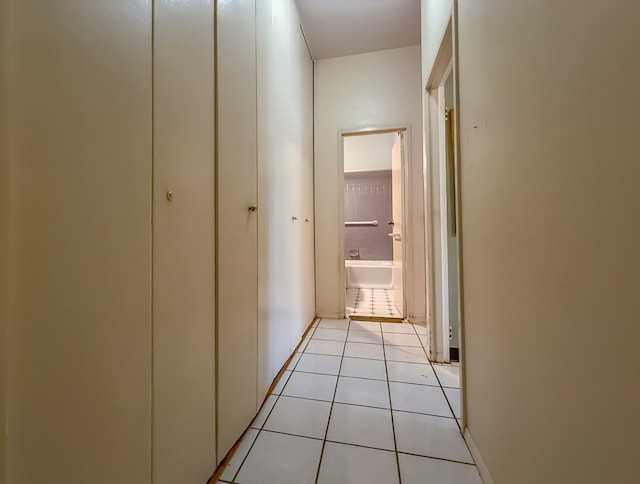 hall with light tile patterned floors and baseboards