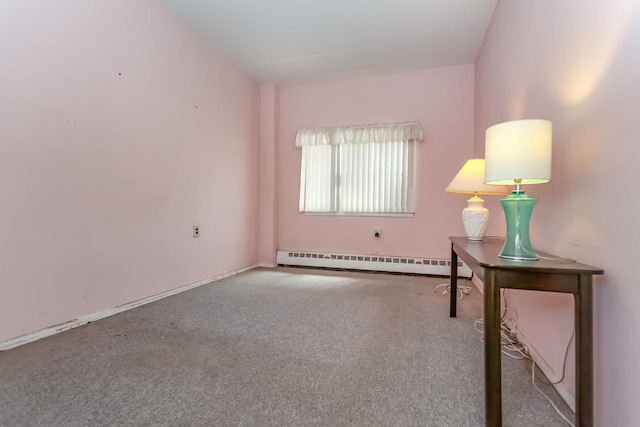 carpeted spare room with baseboard heating