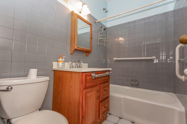 full bathroom with tile walls, vanity, toilet, and bathing tub / shower combination