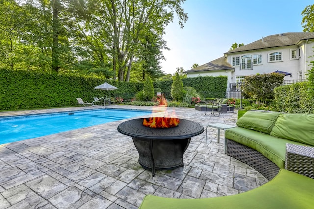view of pool with a patio, an outdoor fire pit, fence, and a fenced in pool