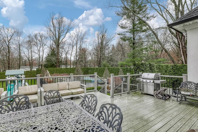 wooden deck featuring area for grilling and outdoor lounge area