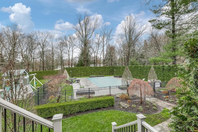 view of yard with fence, a fenced in pool, and a patio area