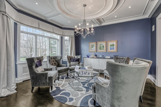 living area with crown molding, coffered ceiling, an inviting chandelier, and wood finished floors