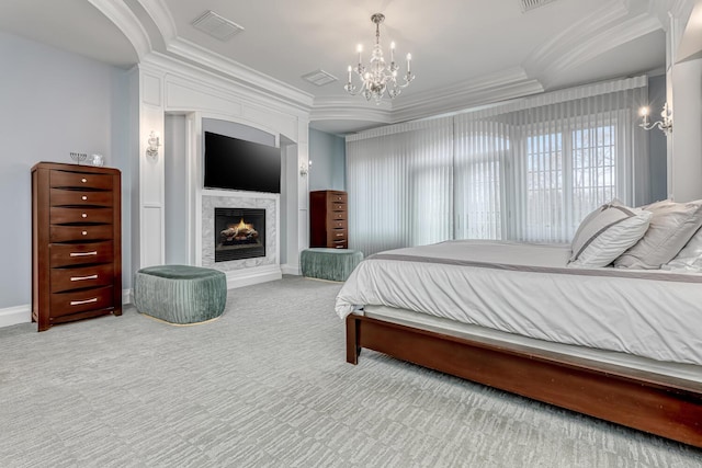 carpeted bedroom with visible vents, crown molding, a notable chandelier, and a lit fireplace