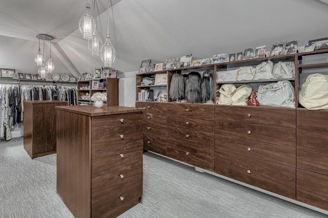 spacious closet with carpet and vaulted ceiling