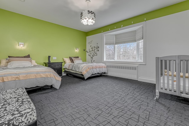 bedroom featuring radiator and carpet