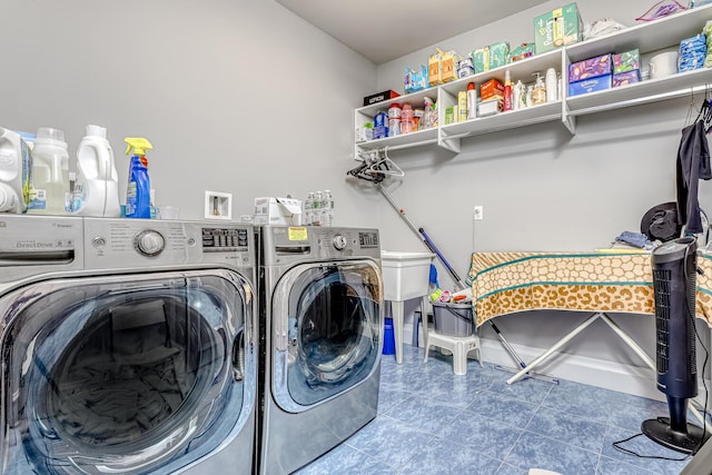 washroom featuring washing machine and clothes dryer, tile patterned flooring, and laundry area