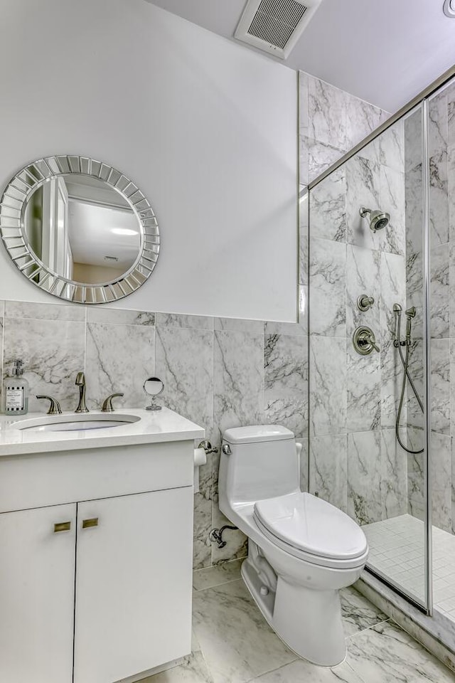 full bathroom with vanity, toilet, marble finish floor, and a marble finish shower