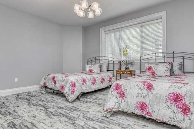 bedroom featuring baseboards and an inviting chandelier