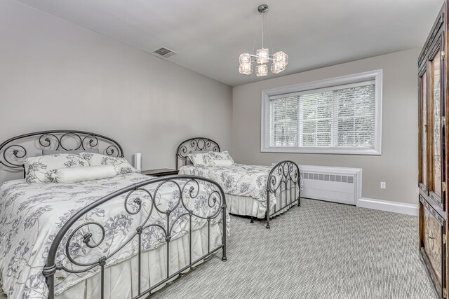 bedroom with a chandelier, radiator, light carpet, baseboards, and visible vents