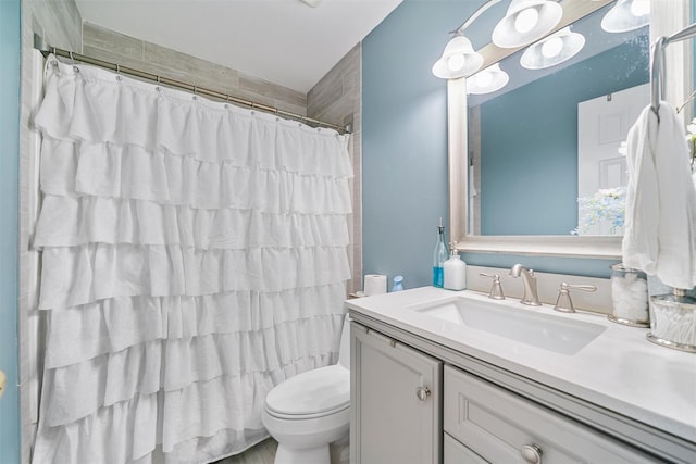 full bathroom with toilet, a shower with curtain, and vanity
