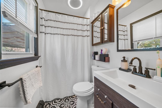 bathroom with vanity, toilet, and a shower with curtain