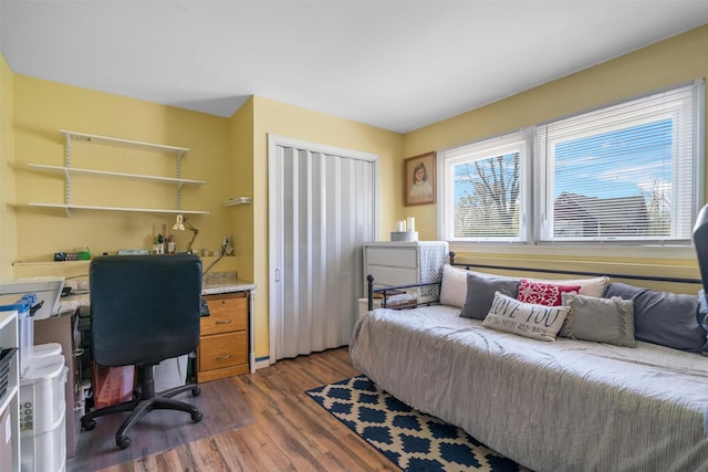 bedroom with a closet and dark wood-type flooring
