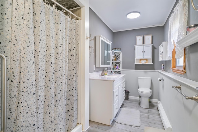 bathroom featuring a baseboard heating unit, vanity, crown molding, toilet, and a stall shower